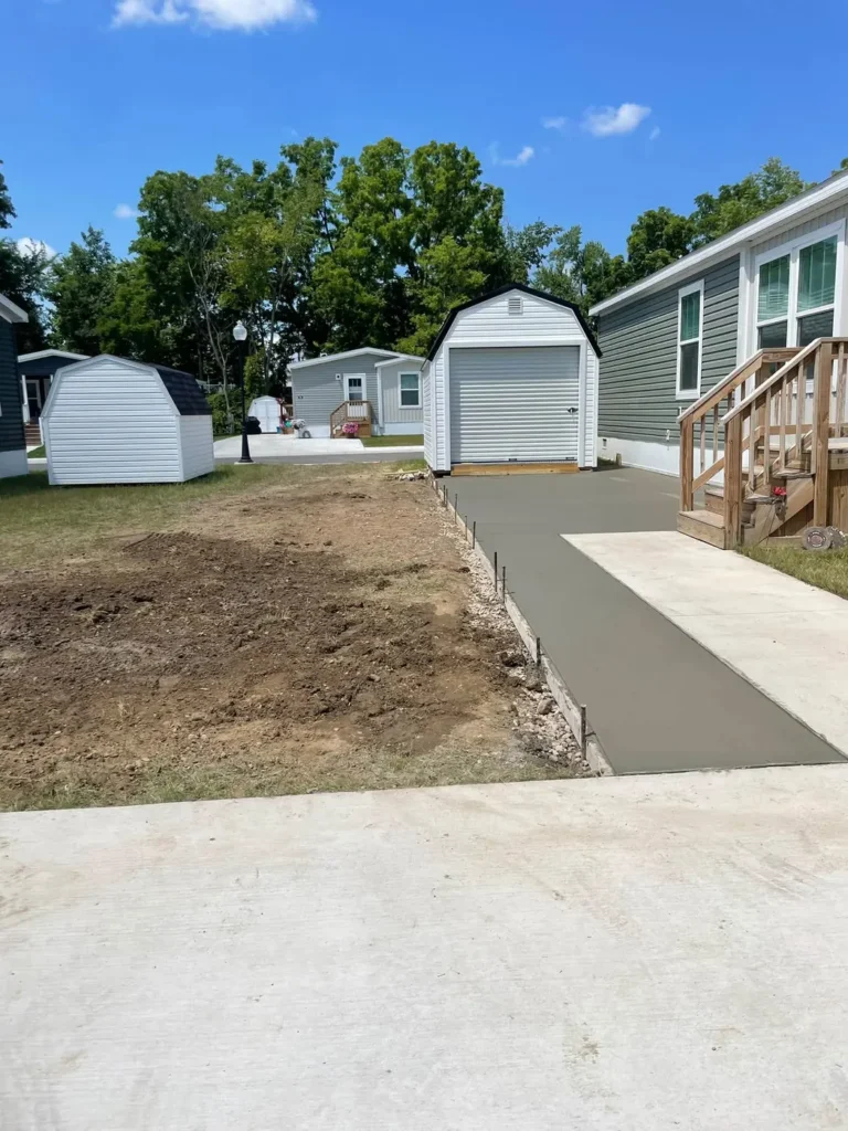 After: fresh concrete driveway poured to a garage shed in Ann Arbor, MI