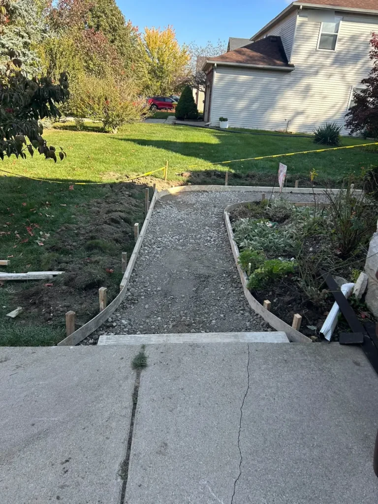 Before: curved walkway forms and gravel base set for a new concrete walkway in Ann Arbor, MI