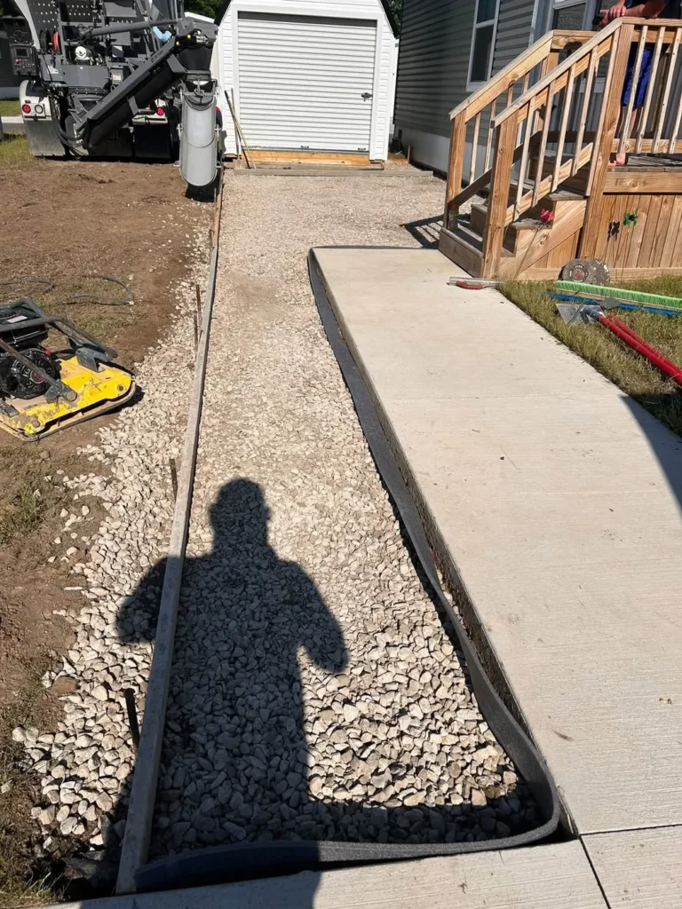 Before: compacted gravel base and forms for a concrete driveway to a shed in Ann Arbor, MI