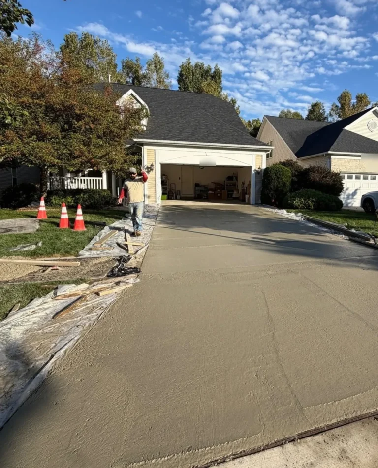 Crew pouring and screeding a new concrete driveway in Ann Arbor Hills, Ann Arbor MI