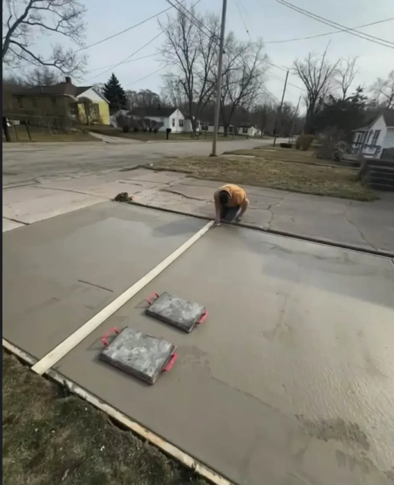 Finishing a fresh concrete driveway pour in Lansdowne, Ann Arbor MI