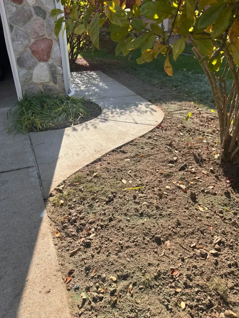 Concrete walkway curving around a garden bed in Georgetown, Ann Arbor MI