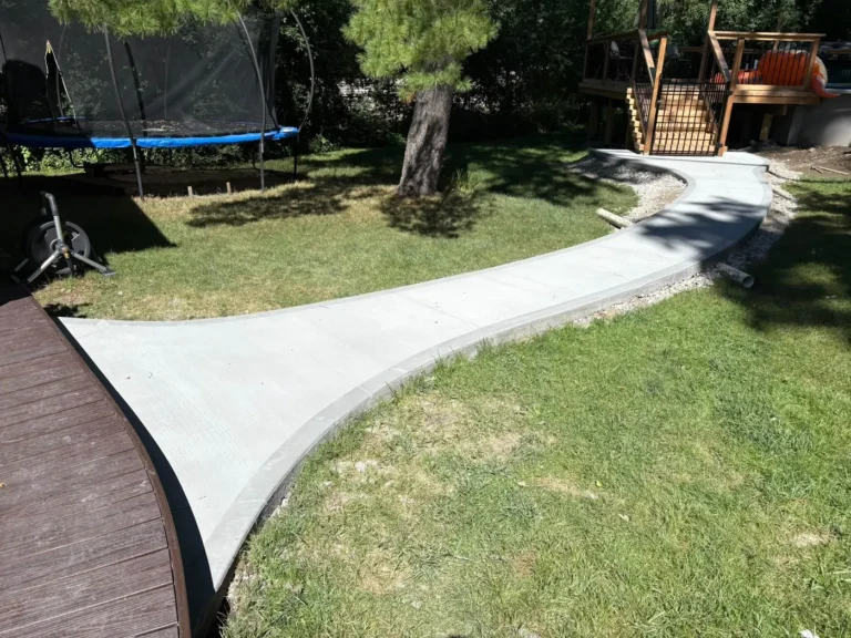 Curved backyard concrete walkway installed in Ann Arbor, MI