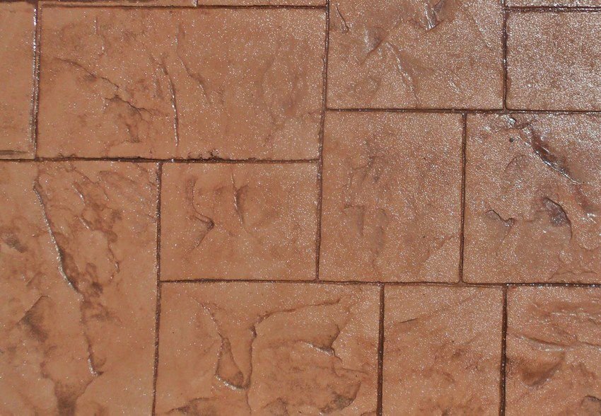 Close-up of brown stone or stamped concrete tiles with a textured pattern