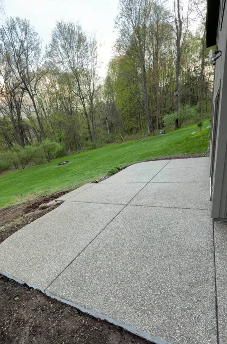 Exposed aggregate concrete patio behind a home in Wildwood Park, Ann Arbor MI